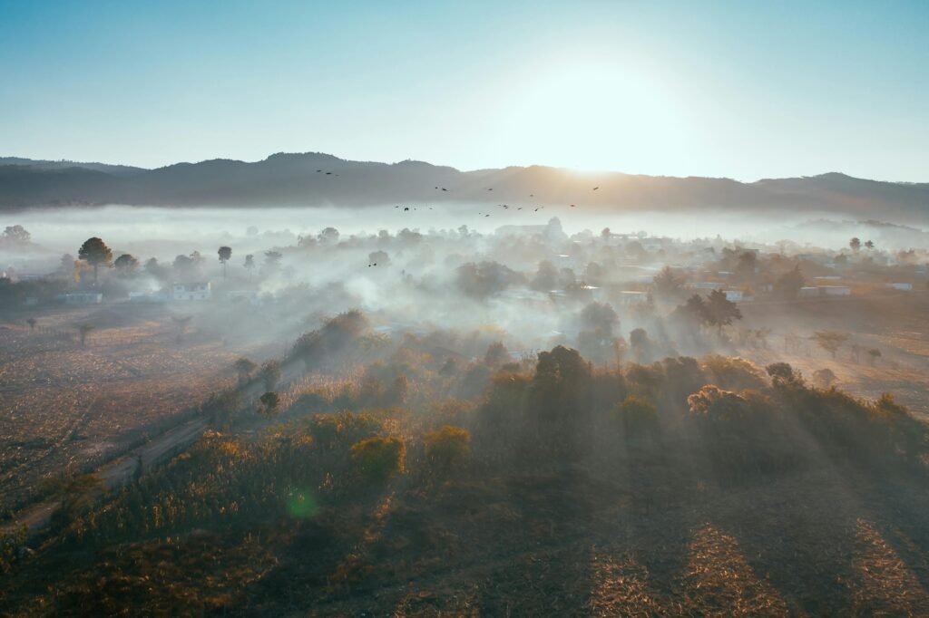 Breathtaking aerial view of a foggy valley during sunrise, showcasing natural beauty and serenity of Santa Fe, New Mexico.