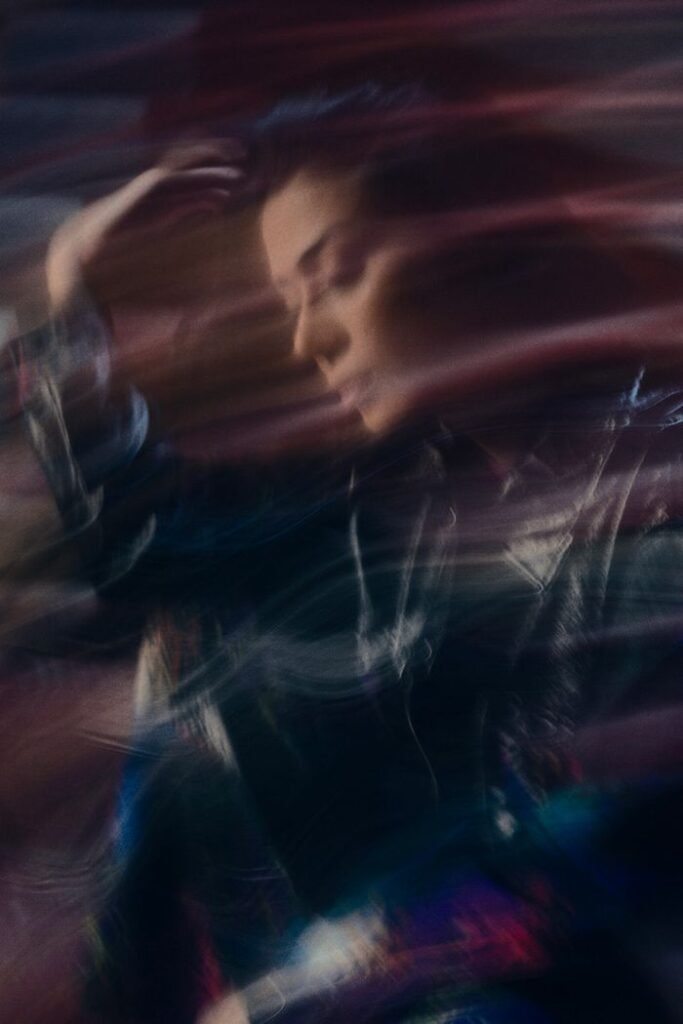 A creative and artistic portrait of a woman with motion blur effect.